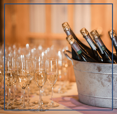 Champagne bottles in metal ice bucket with glasses of champagne on a table at Southside Steakhouse.