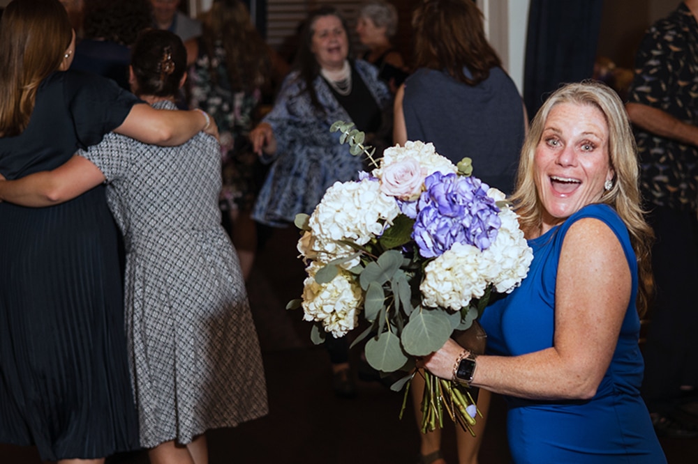 Woman holding a decorative bouquet at a special occasion event at Southside Steakhouse, a versatile Vermont venue for celebrations and private gatherings.
